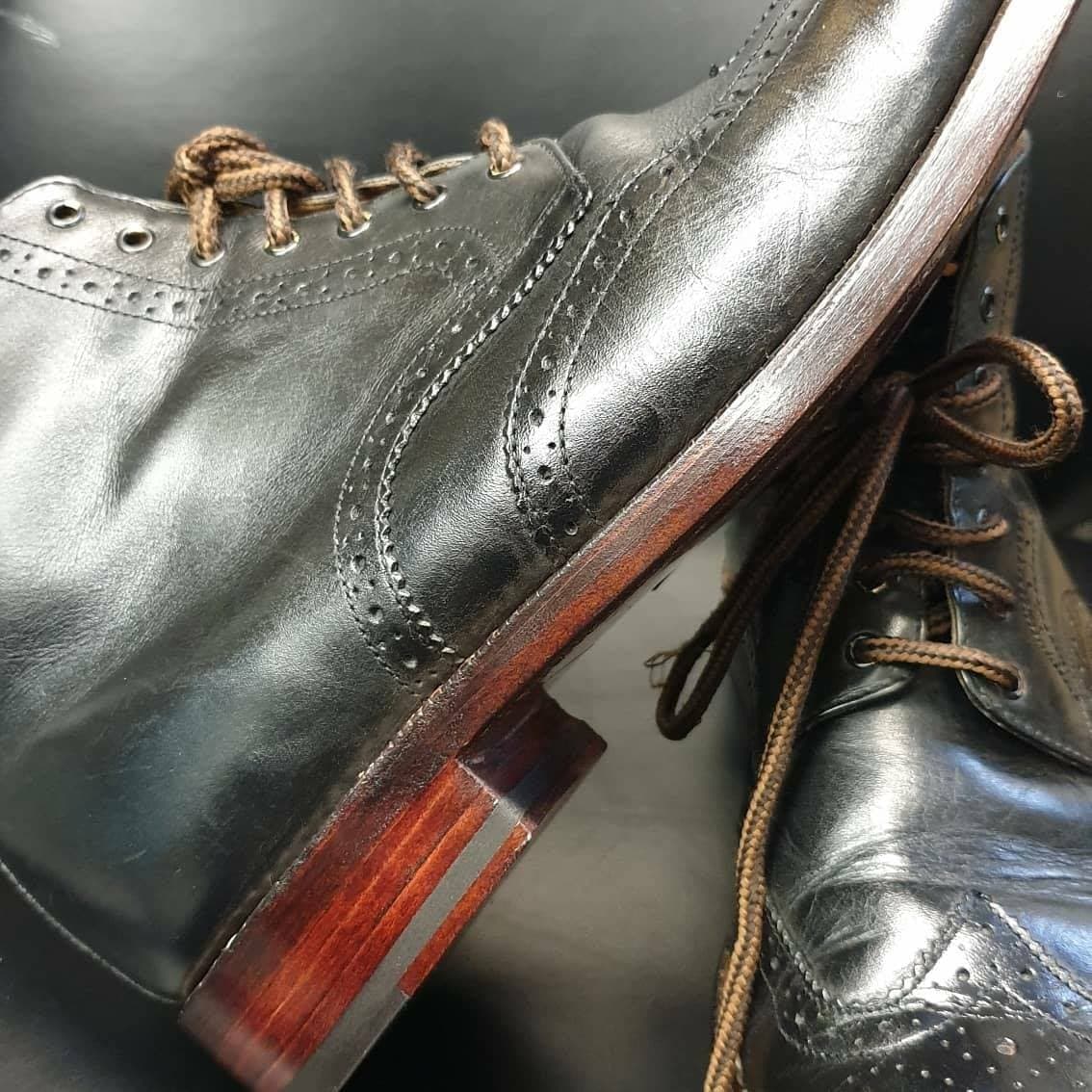 Black leather wingtip brogue boots resoled by expert London cobbler